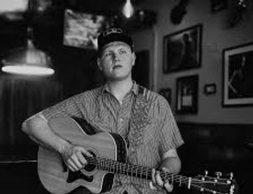 Brooks Werner sitting with a guitar.