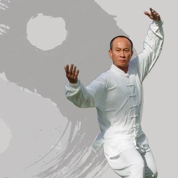 Man practicing Tai Chi in white traditional outfit.