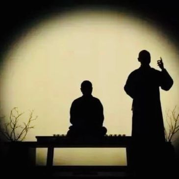 Silhouettes of two people against a large circular light.