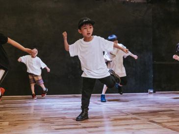 Young boy dancing in a studio.