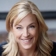 Smiling blonde woman with layered hair.