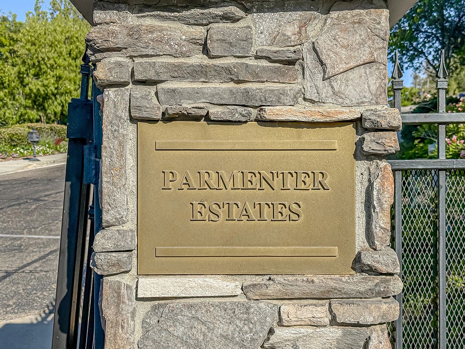 Stone pillar with a brass plaque reading 'Parmenter Estates'.