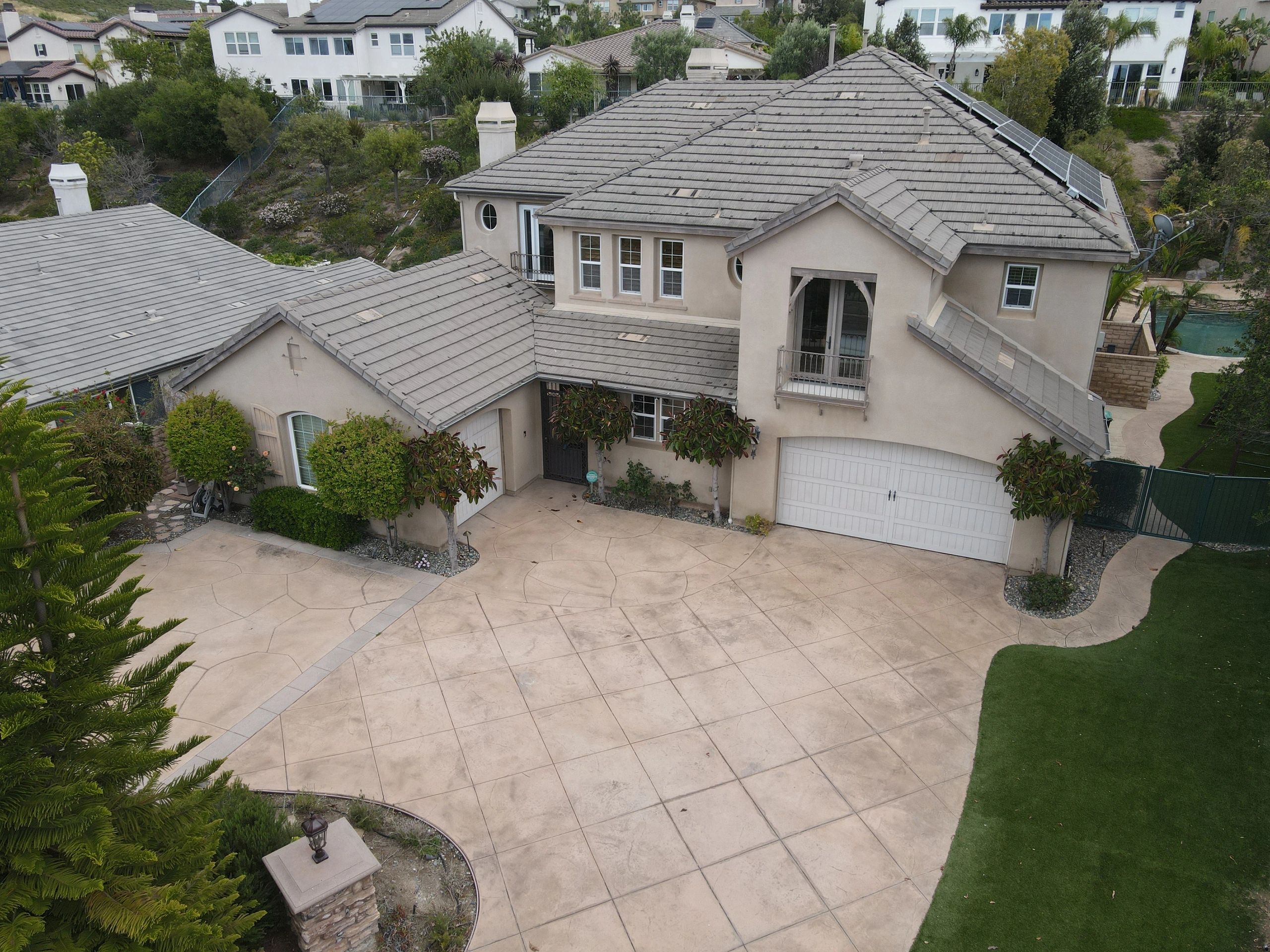 Spacious suburban home with a large driveway and a well-maintained lawn.