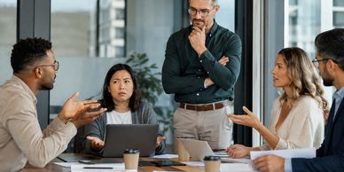 Colleagues engaged in a discussion in a modern office.