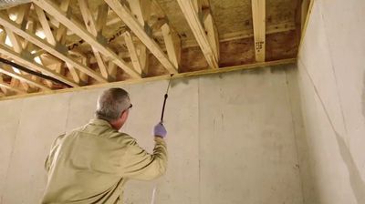 Man spraying wood