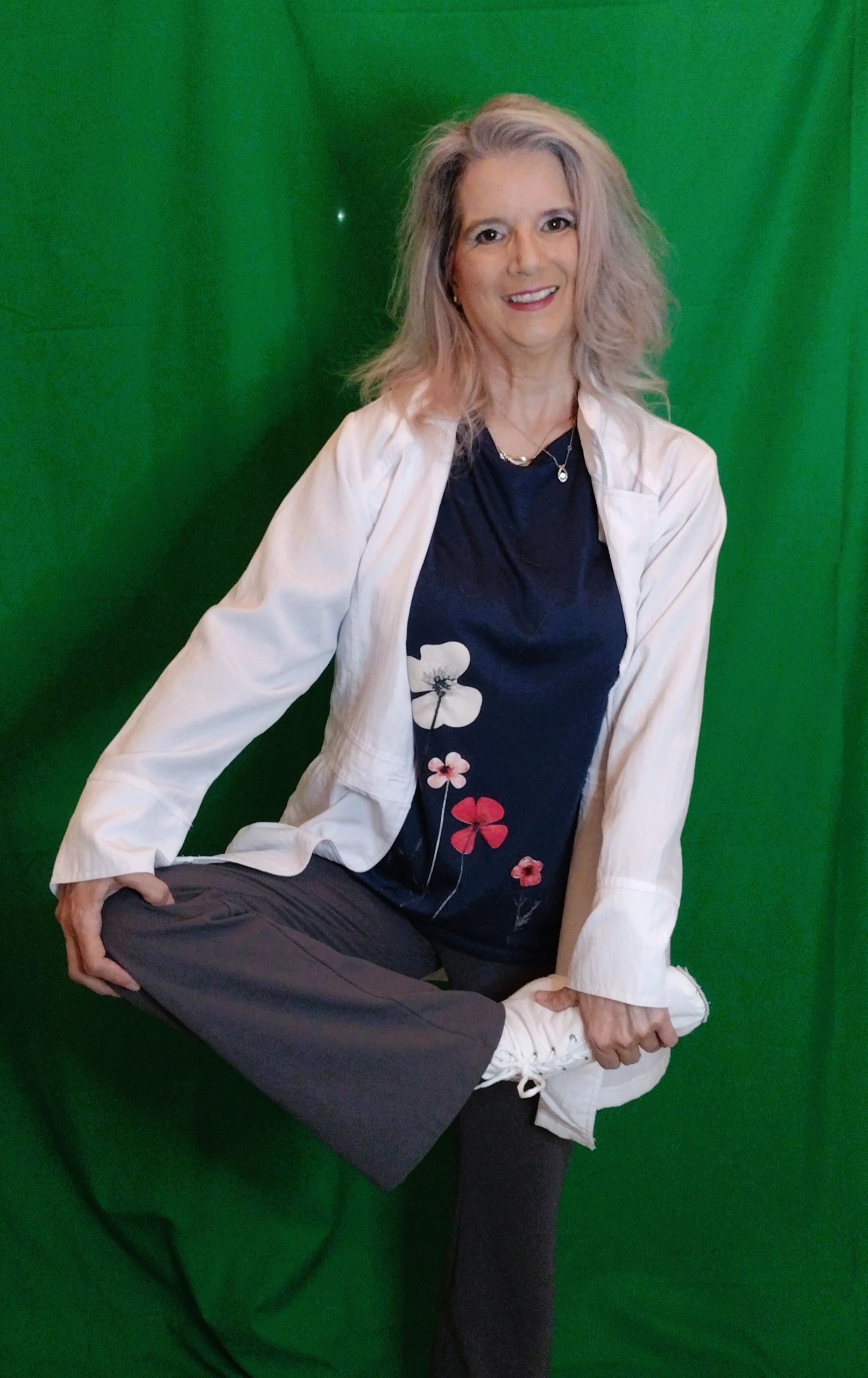 Dr. Turner Balanced on one leg with green curtain behind her.