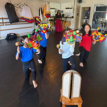 Kids and adults learning Venezuelan folk dance in a Bay Area dance class with colorful traditional c