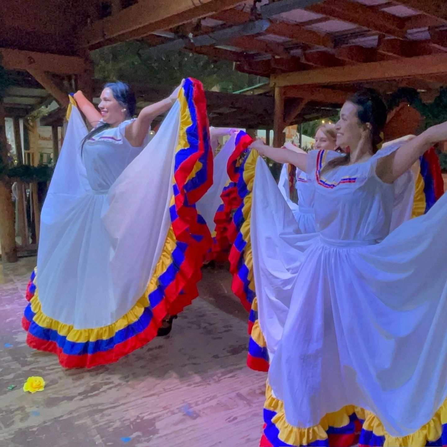 Dulce Tricolor Venezolano dancers performing Venezuelan folk dance in traditional colorful dresses, 