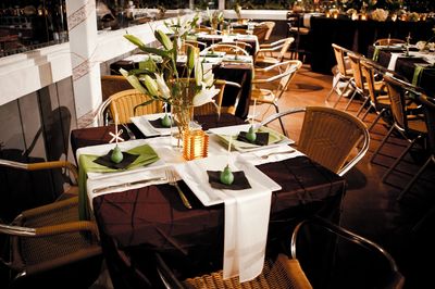 Elegant restaurant table setting with flowers and folded napkins.