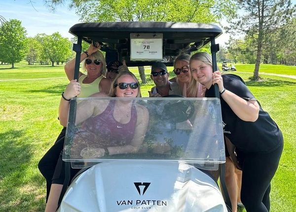 Bill Benton's family on golf cart