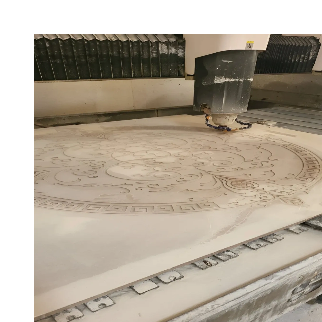  carving in Semi Precious intricate circular floral design onto a large stone or marble slab.