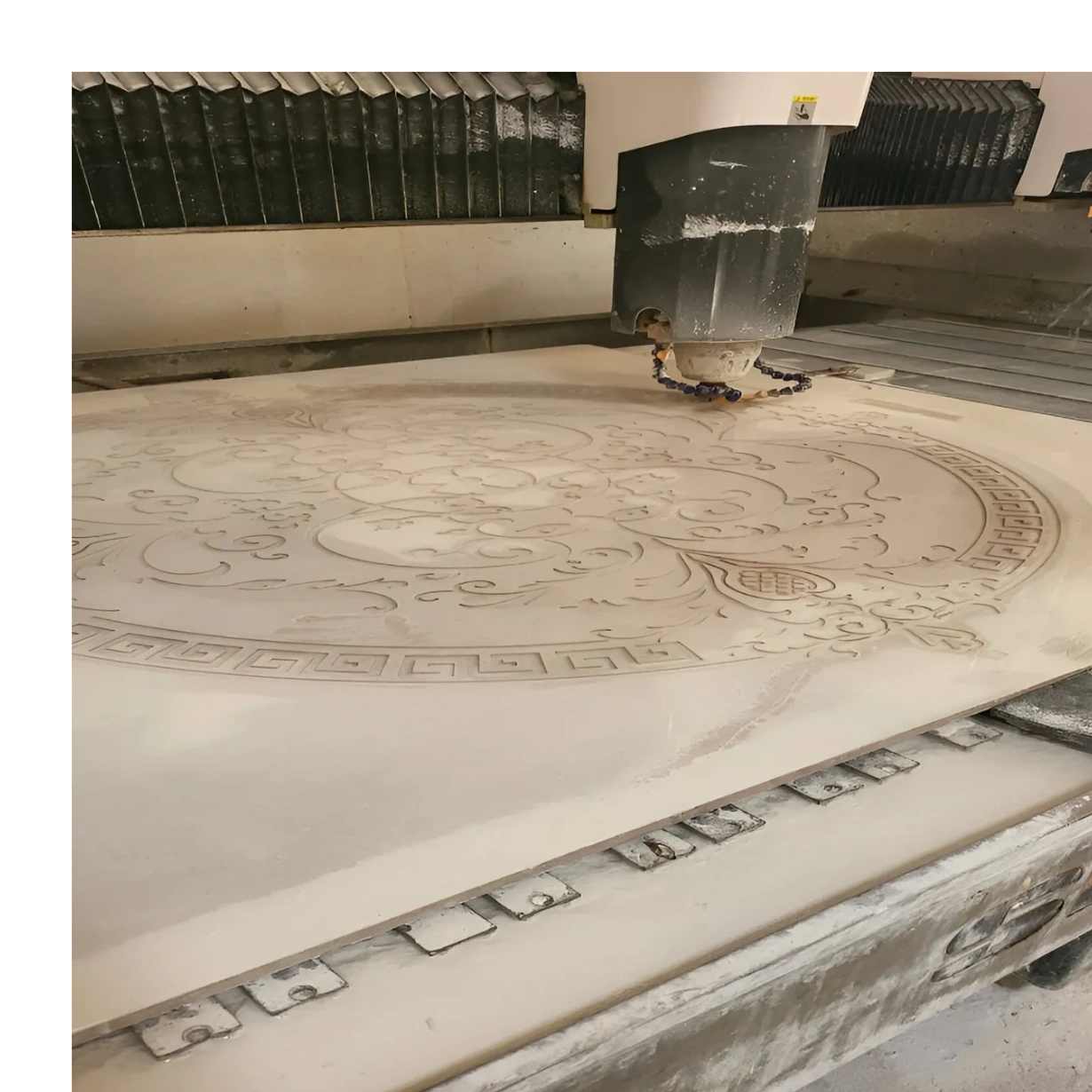  carving in Semi Precious intricate circular floral design onto a large stone or marble slab.