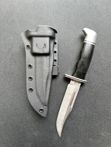 This sheath has a combat Lok mounted integrally and has a logo stamp on the front.