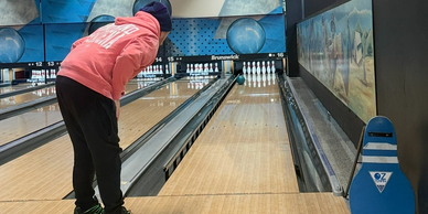 Person preparing to bowl at a bowling alley.