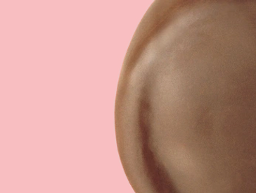 Close-up of a chocolate candy against a red background.