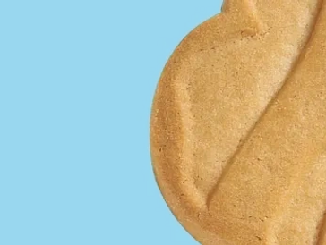 Close-up of a textured cookie against a blue background.