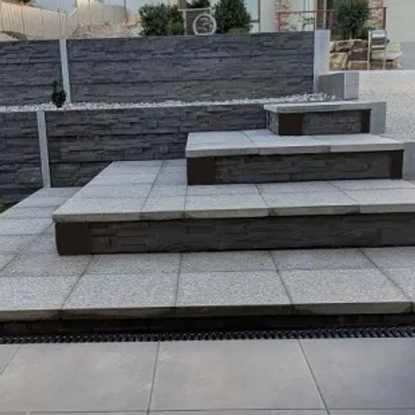 Stone paving and concrete sleeper retaining wall with steps in Hewett