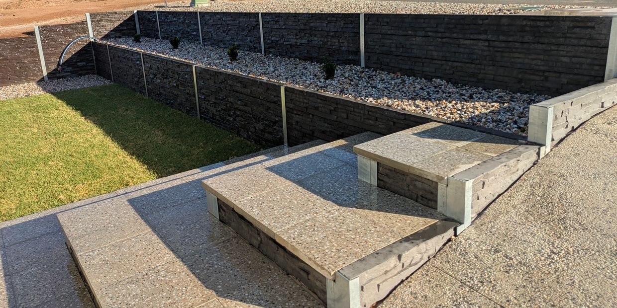 retaining wall using concrete sleepers with matching steps built with stone pavers in Adelaide