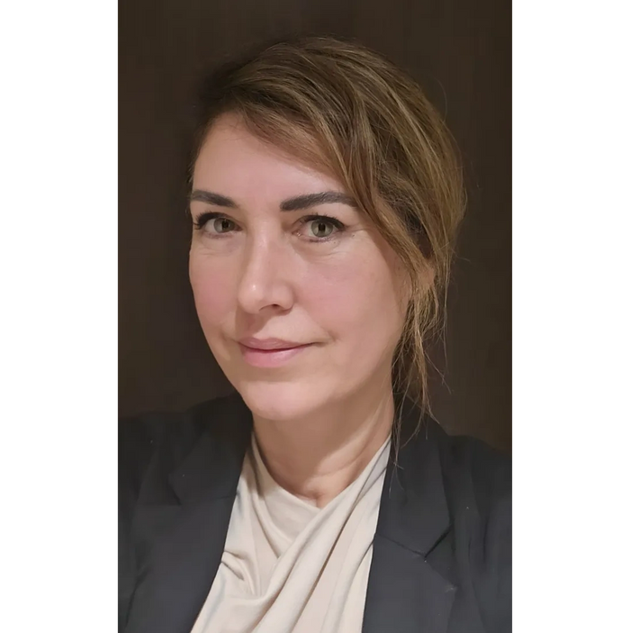 Woman attentively listening during a conversation in a cozy room.
