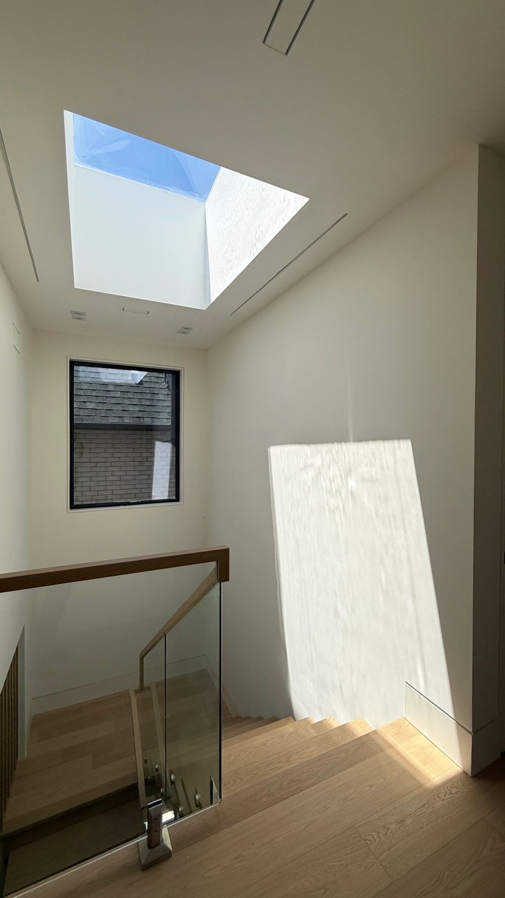 Modern stairway with skylight and natural light.