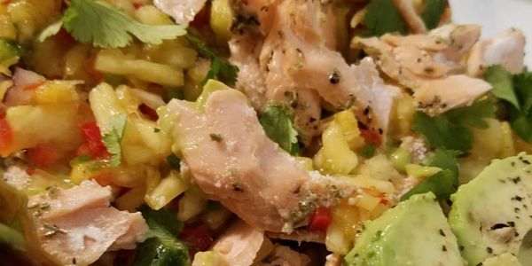 Salmon Seabreeze Nachos 
Grilled Salmon, avocado lime sauce, cilantro and a pineapple salsa over cri