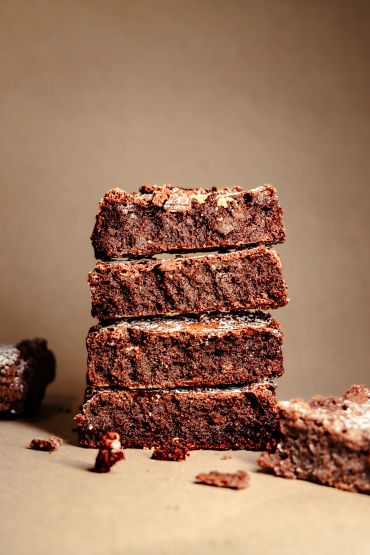 Stack of four chocolate brownies.
