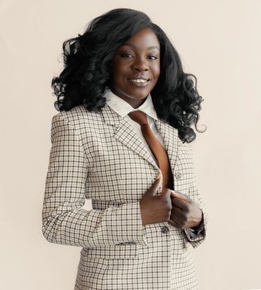 Confident woman in checked suit smiles warmly.