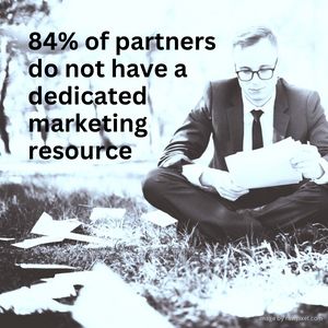 Man in a suit sitting on the grass, looking at papers with annotion:84% of partners do not have a de…