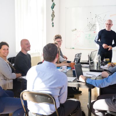 People working at a conference table together, smiling