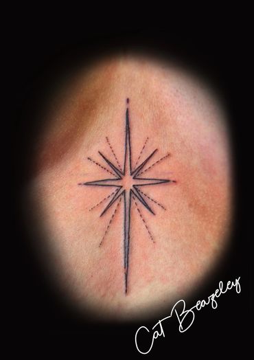 Starburst sternum tattoo by Cat Beazeley tattoo 