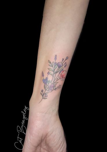 Pretty, delicate fine line flowers with a splash of colour by Cat Beazeley tattoo 