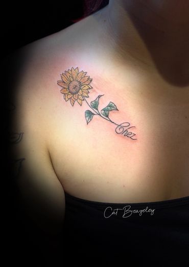 Meaningful sunflower collarbone piece by Cat Beazeley tattoo 