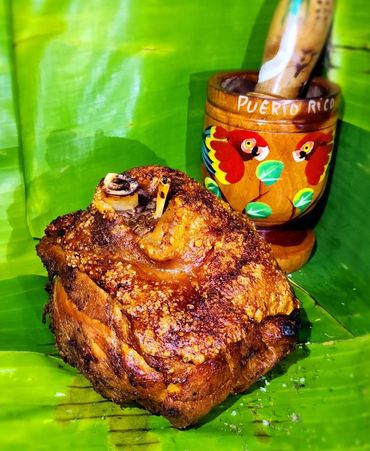Crispy roasted pork on a banana leaf with Puerto Rico mortar.