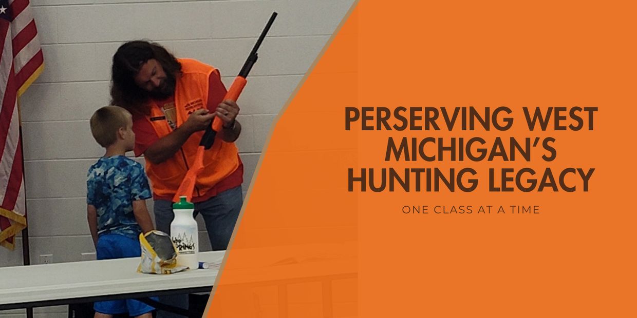Man teaches young boy about hunting with an orange training rifle indoors.