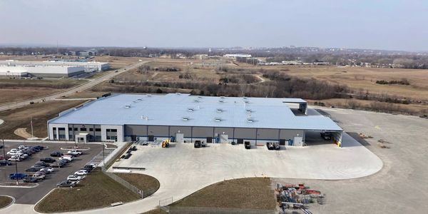An aerial shot of the entirety of a large warehouse building. 