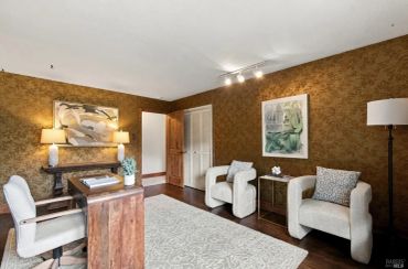 Cozy home office with neutral tones and comfortable seating.