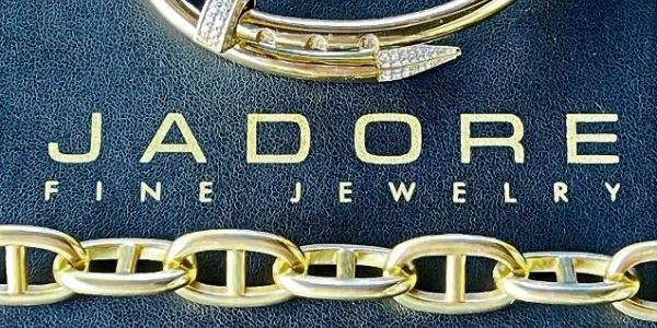 Gold jewelry on JADORE Fine Jewelry background.