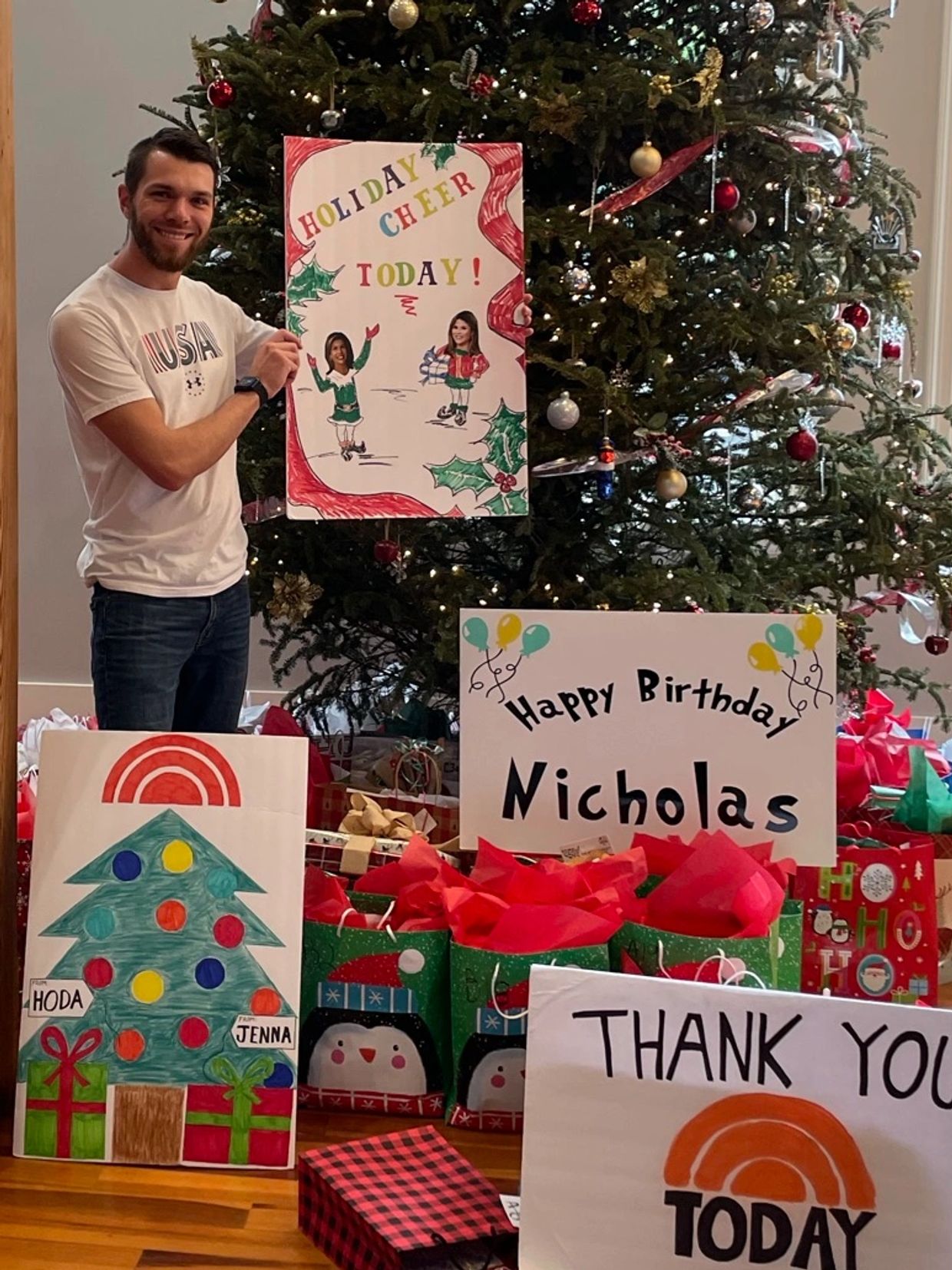 Nicholas Newell posing with poster boards made by NBC Universal Today Show Staff