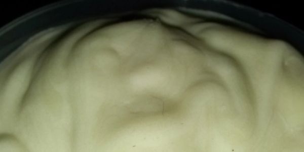 Close-up of creamy white substance in a transparent container.