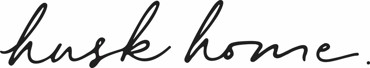 Handwritten phrase 'husk home.' in black ink on white background.