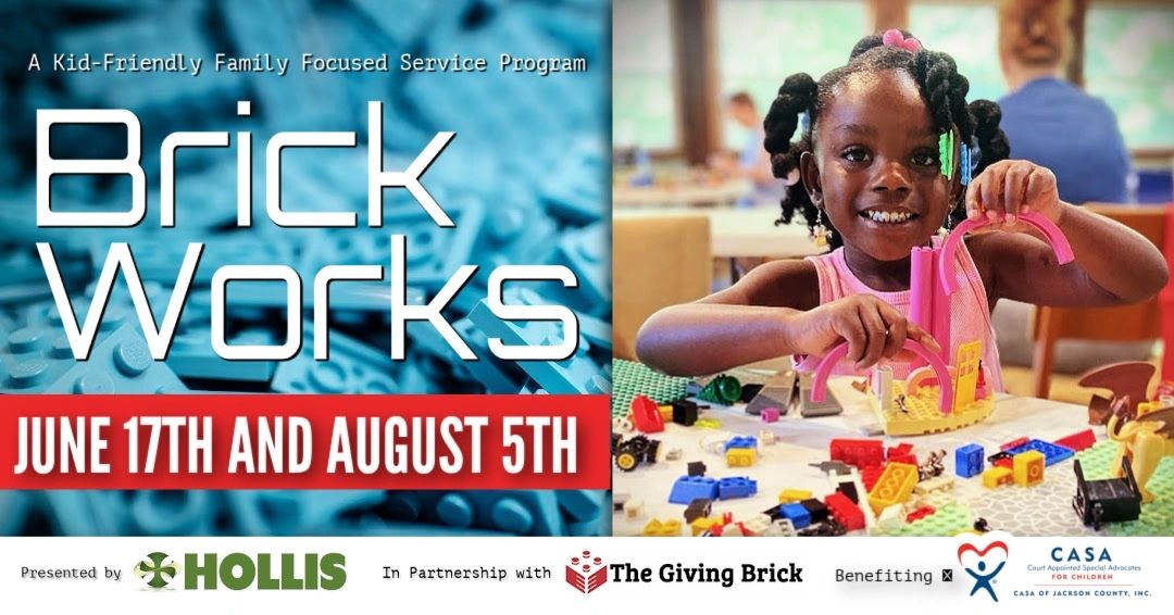 A young girl happily plays with colorful building bricks at a family-focused event.