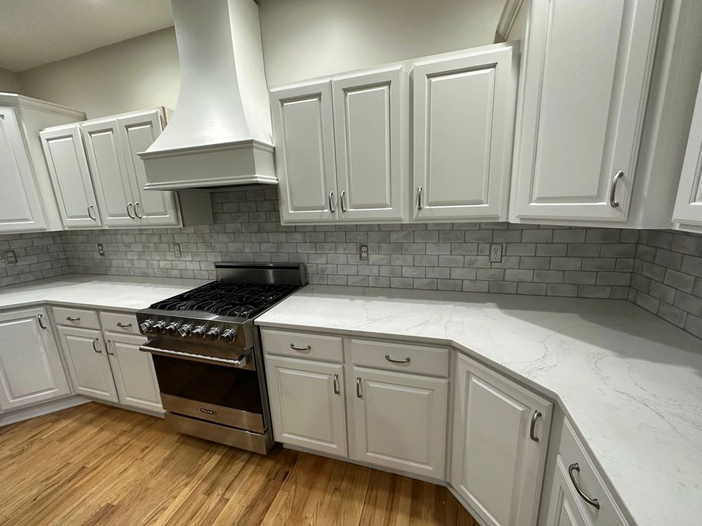 Built and installed stove hood and updated backsplash tile.
