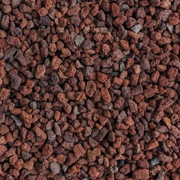 Close-up of porous lava rocks in varying shades of red and brown.