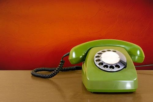 a green color telephone 