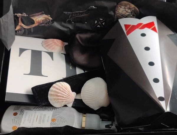 Gift box with seashells and skincare product.