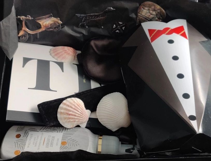 Gift box with seashells and skincare product.