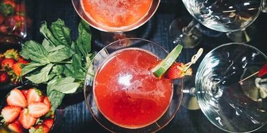 strawberry-basil cosmopolitan in a martini glass, mint, lime, strawberry