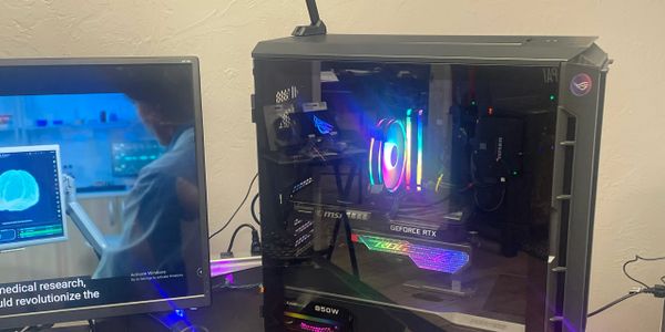 Gaming PC with RGB lighting and GeForce RTX graphics card beside a monitor.