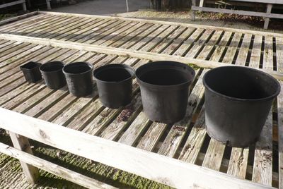 line of different sized empty pots 