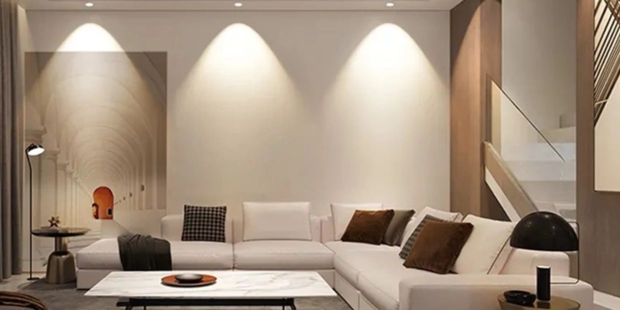 Modern living room with white sectional sofa and ambient lighting.
